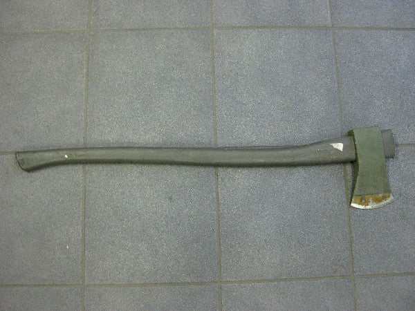 Vintage axe with long handle on a tiled floor, potential slight damage due to age. Vintage axe with long handle on a tiled floor, potential slight damage due to age.